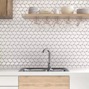 White Leafy tile backsplash installed on the wall of a kitchen with grey wooden cabinets and white stone countertop.