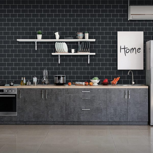 Black Subway tile backsplash installed on the wall of a large kitchen with black wooden cabinets.