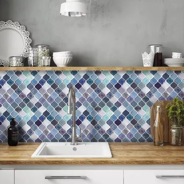 Coronate Botanical tile backsplash installed on the wall of a kitchen with white cabinets and wooden countertop.
