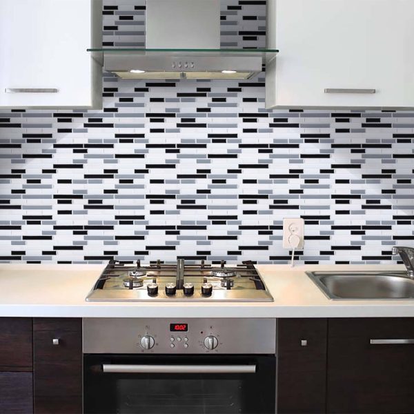 Grey and Black Marble tile backsplash installed on the wall of a kitchen with black wooden cabinets and white stone countertop.