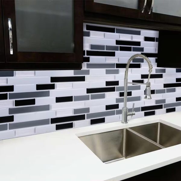 Grey and Black Marble tile backsplash installed on the wall of a kitchen with white stone countertop.
