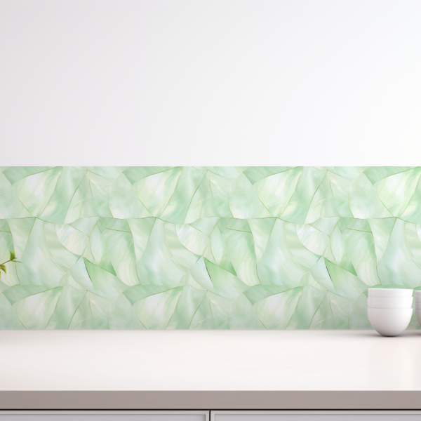Light Green Mother of Pearl tile backsplash installed on the wall of a brightly lit kitchen with white stone countertop.