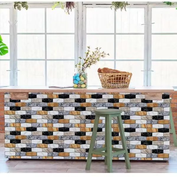 Multicolor Stones tile backsplash installed on the wall of a kitchen with grey wooden cabinets and white stone countertop.