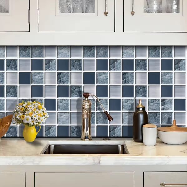 Slate Square Mosaic tile backsplash installed on the wall of a kitchen with grey wooden cabinets and white stone countertop.