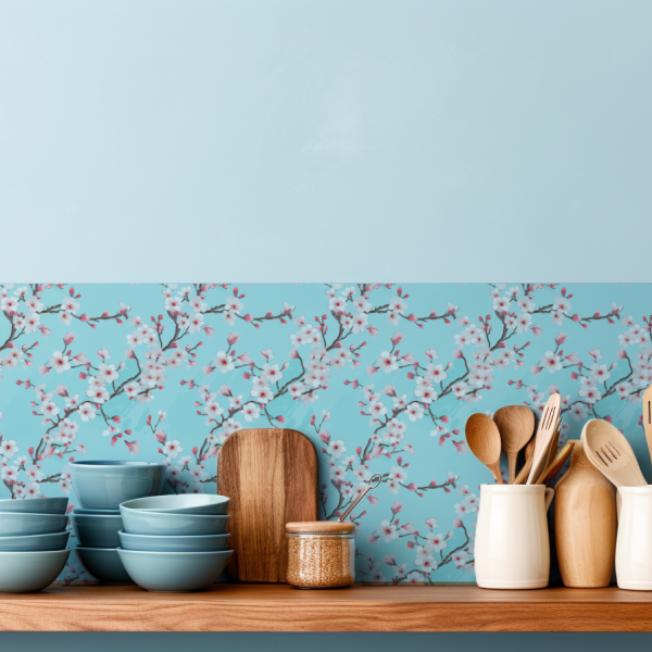 Turquoise Cherry Blossoms tile backsplash installed on the wall of a kitchen with wooden countertop and light blue utensils.